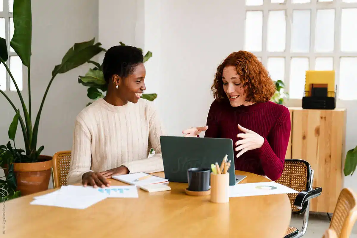 Two women doing business at a table