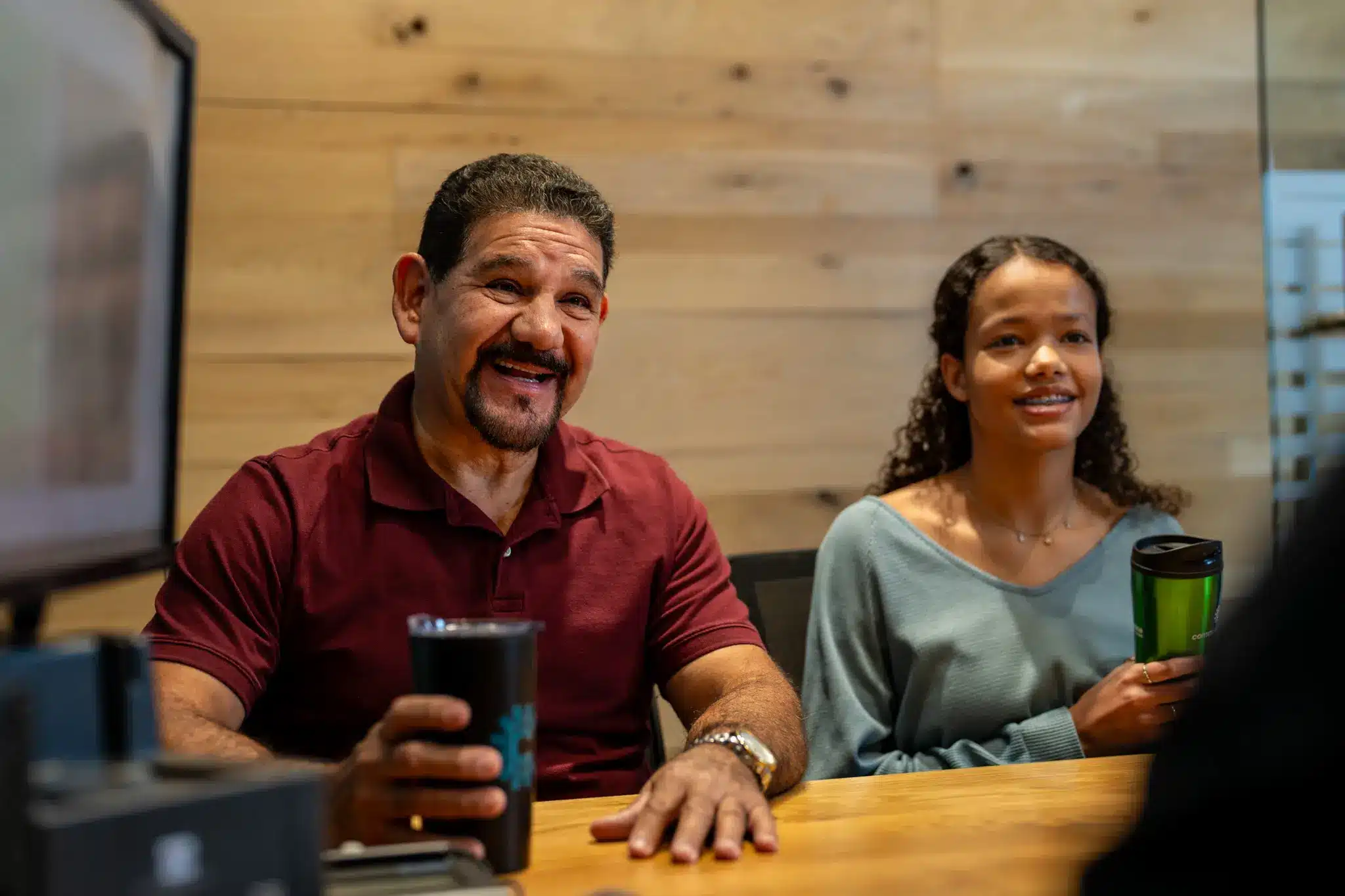 A happy couple meets with their adviser at a Community Choice member center.