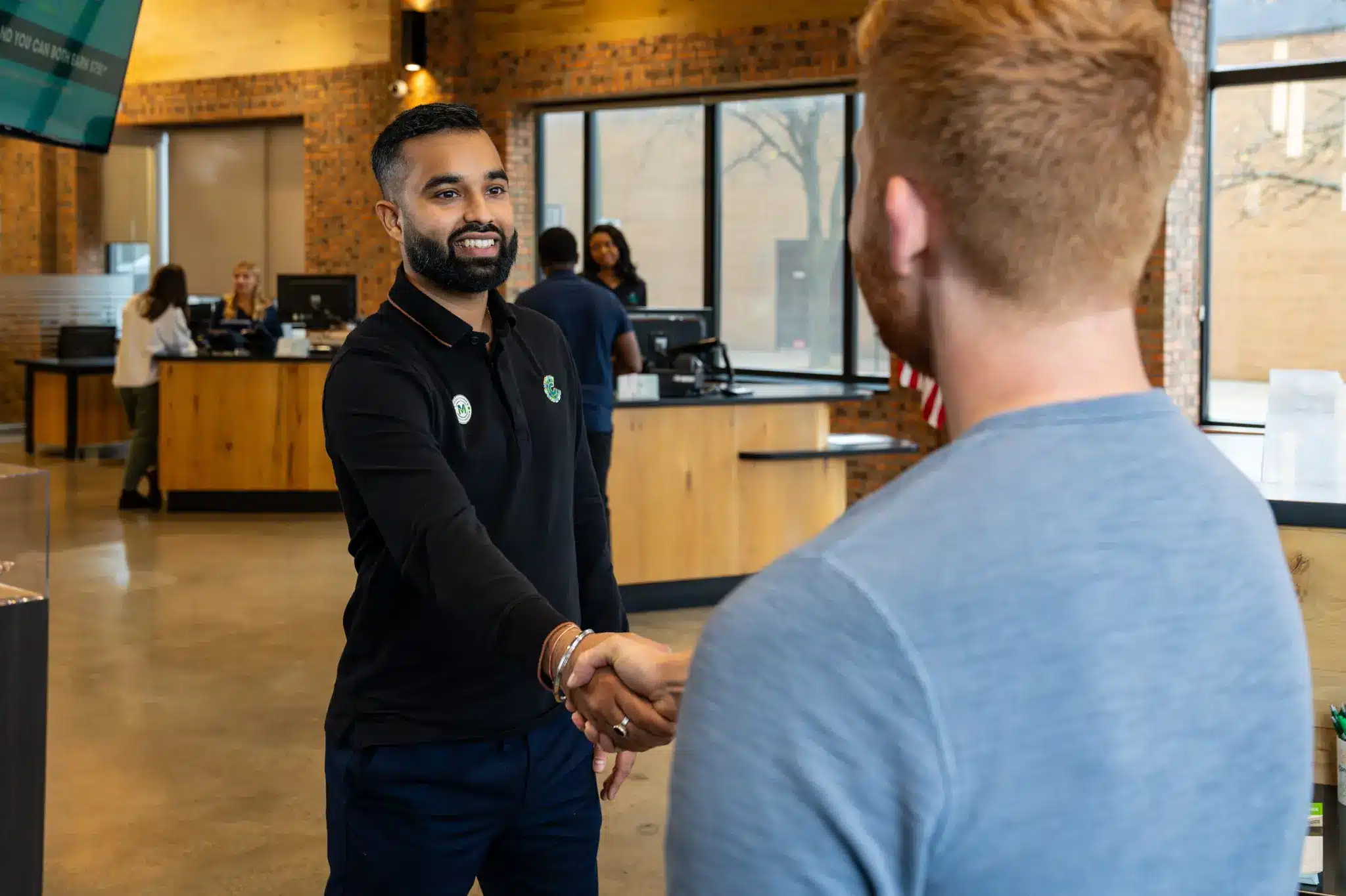 A Community Choice team member greets a guest.