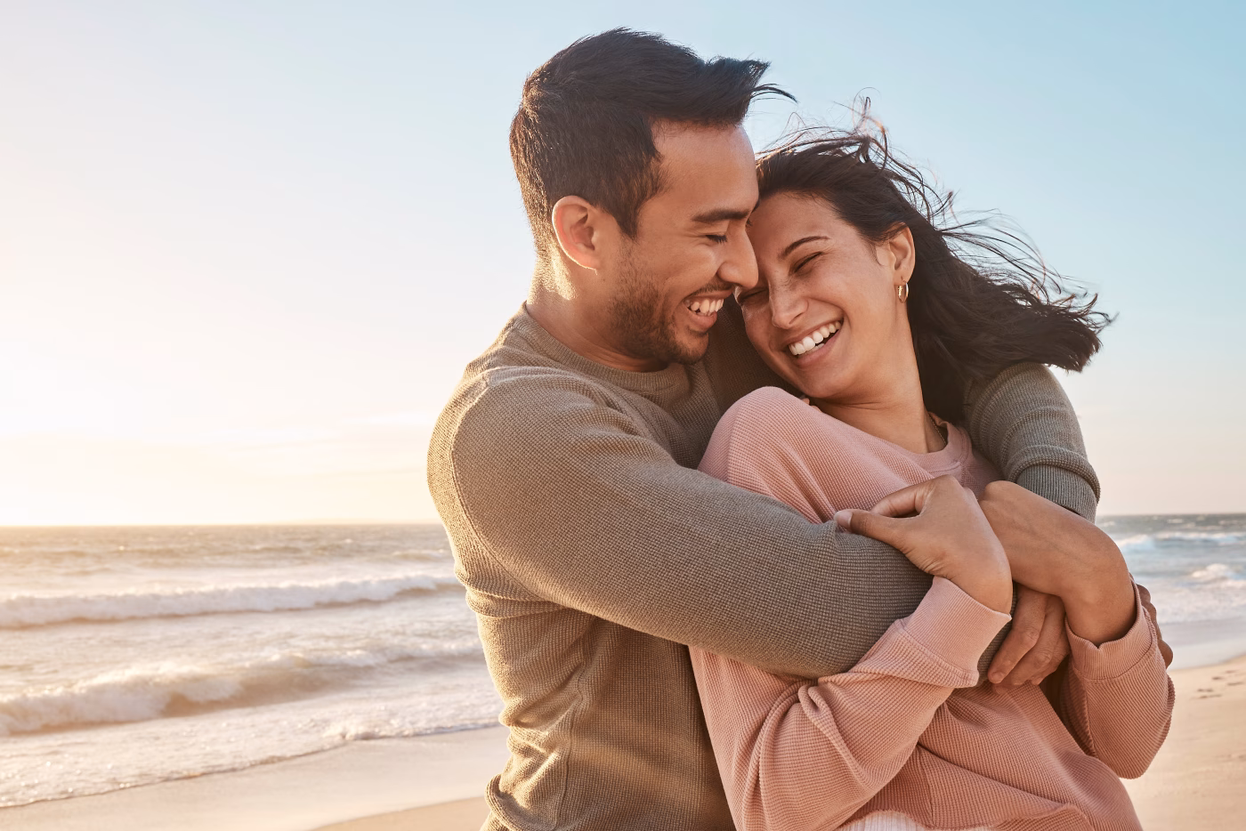 A couple relaxing on the beach, worry free thanks to Community Choice Credit Union in Michigan.