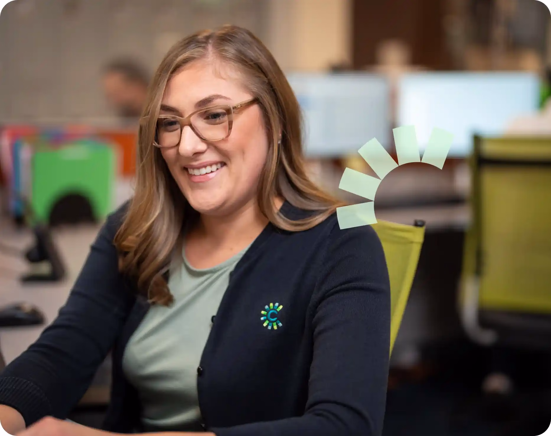 A Community Choice employee sitting at her desk smiling