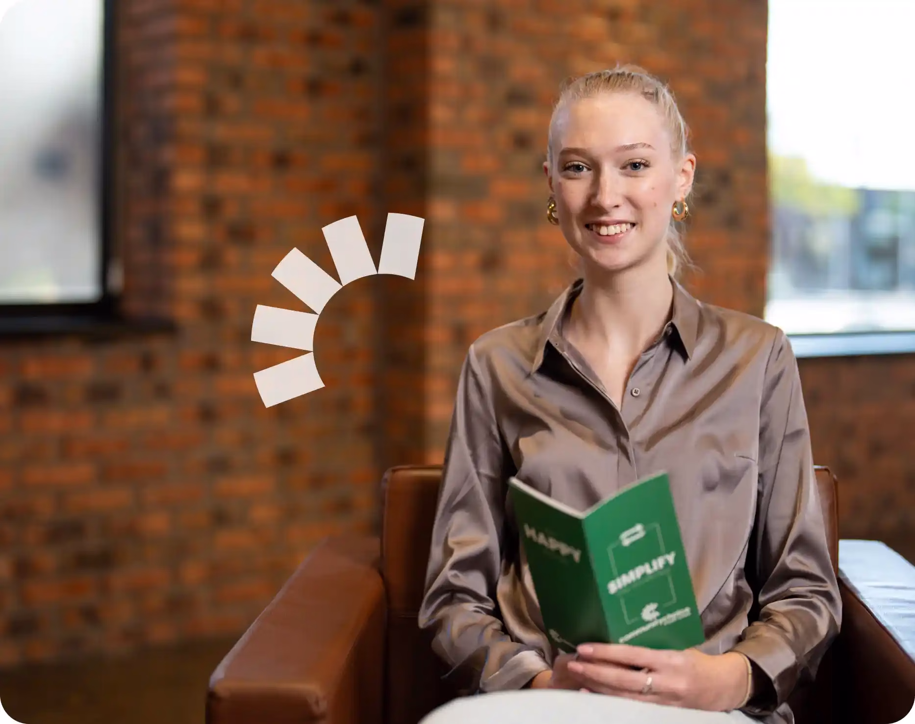 A woman in a chair holding a Community Choice Choice Map brochure