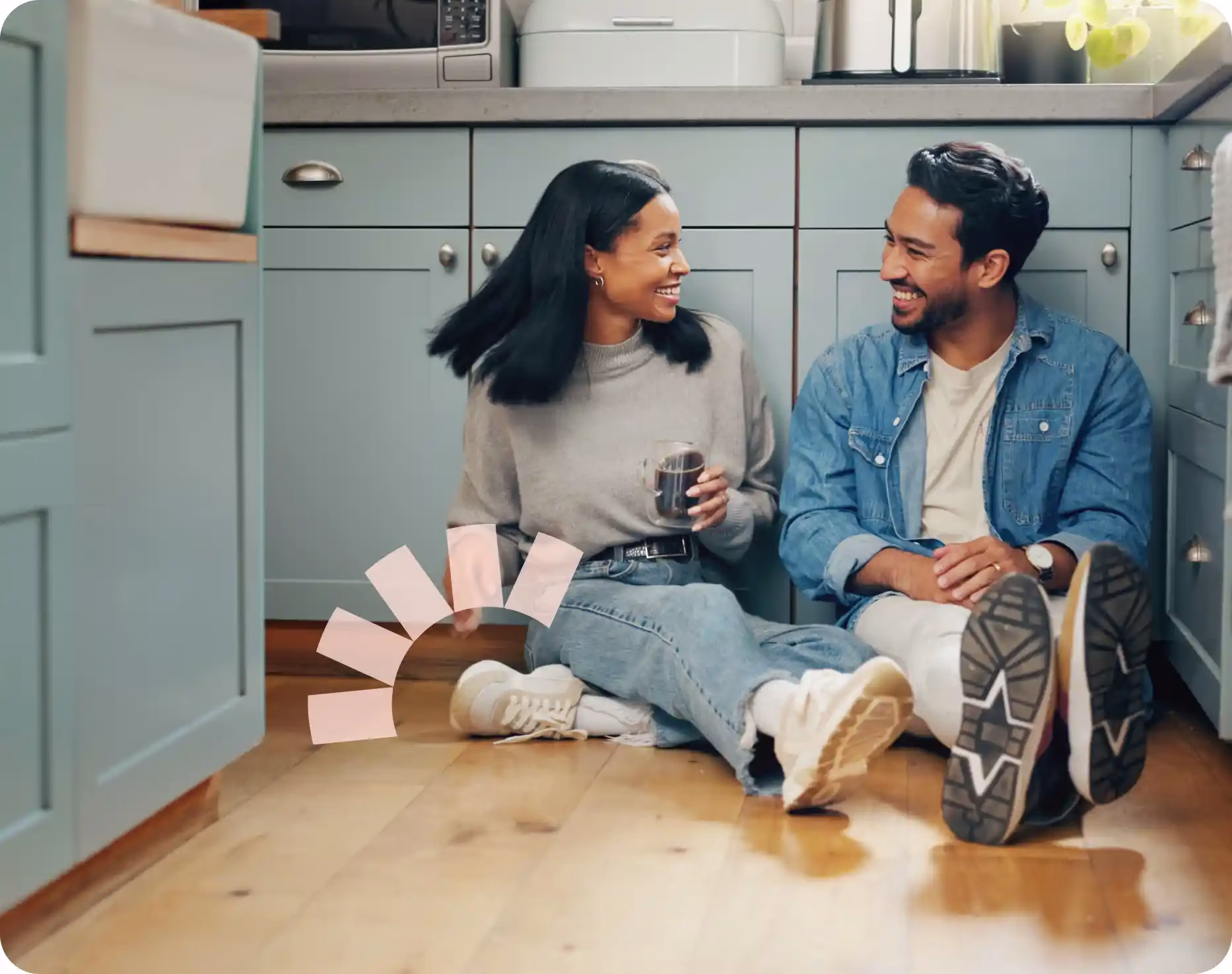 Two people sitting on the ground of their new home