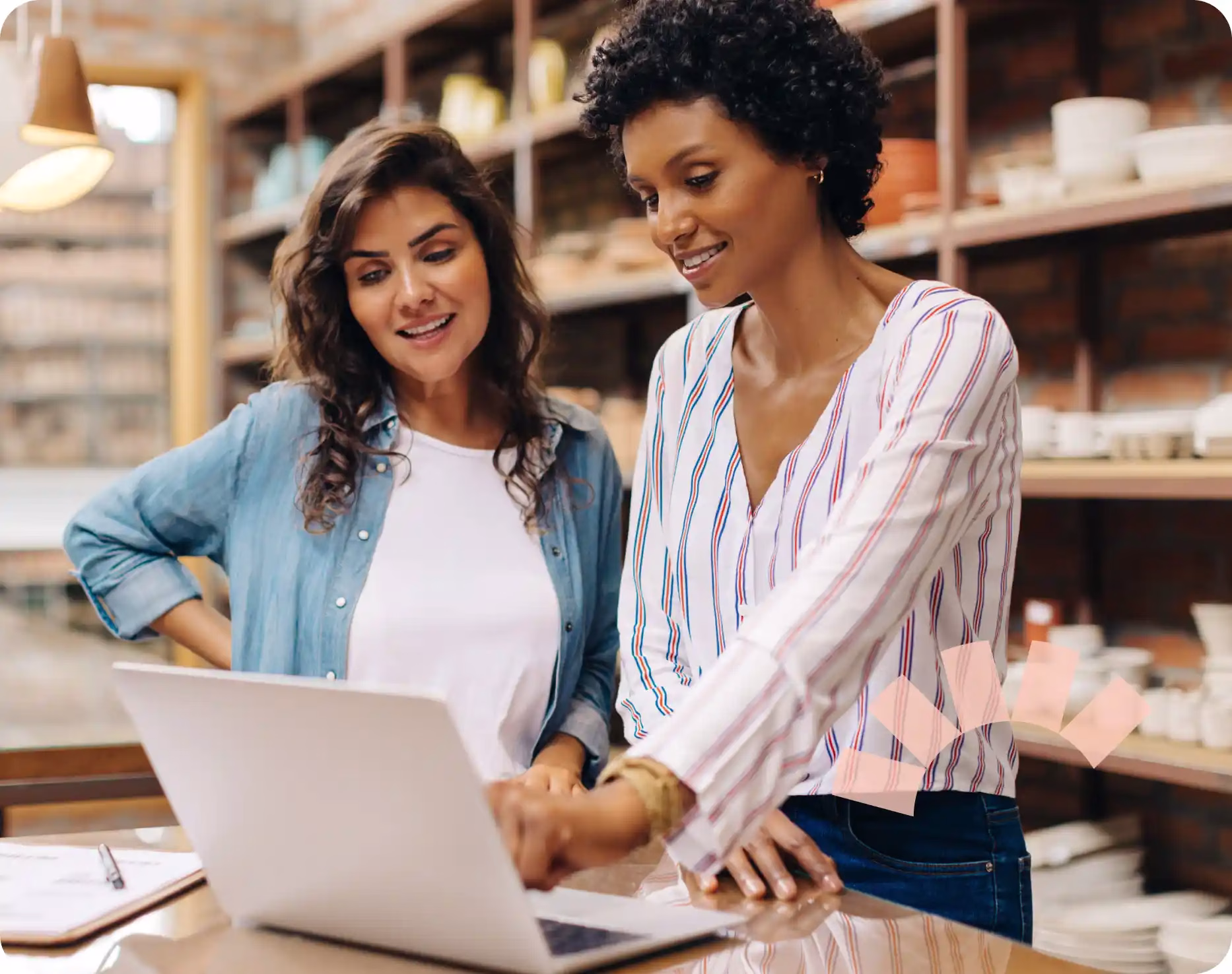 Two women in a business discussing Community Choice's SBA loans