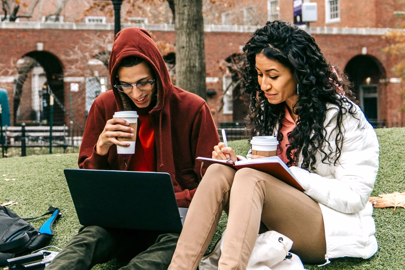 Two college students sitting on campus studying | Student Loans | Community Choice Credit Union