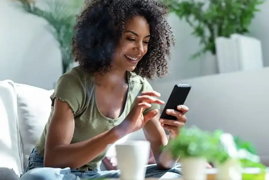 A woman enjoys the ease of online banking with Community Choice Credit Union