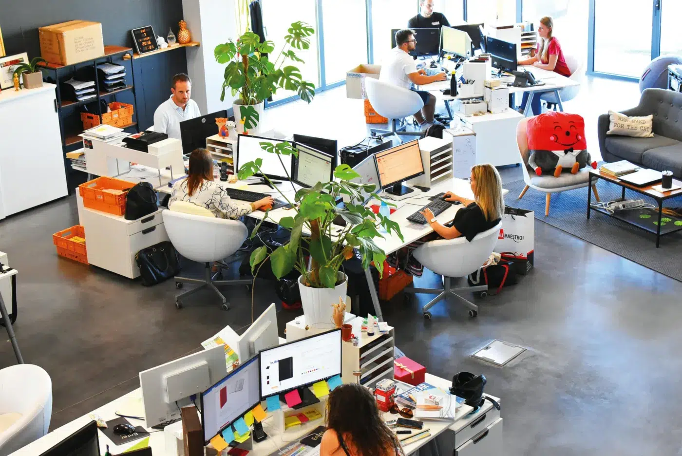 A busy office with people working.
