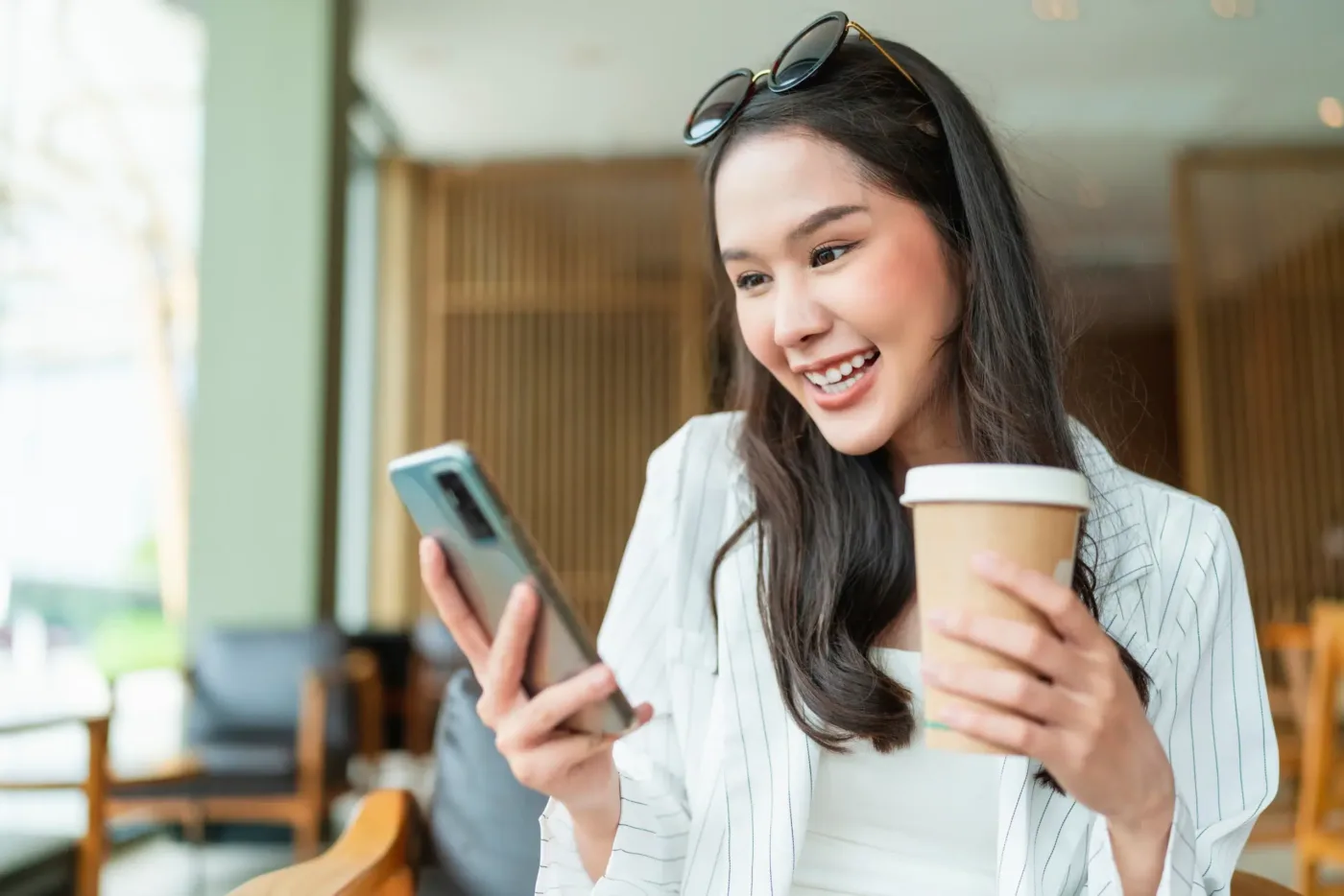 A woman using her phone to check her special offers from Community Choice Credit Union.
