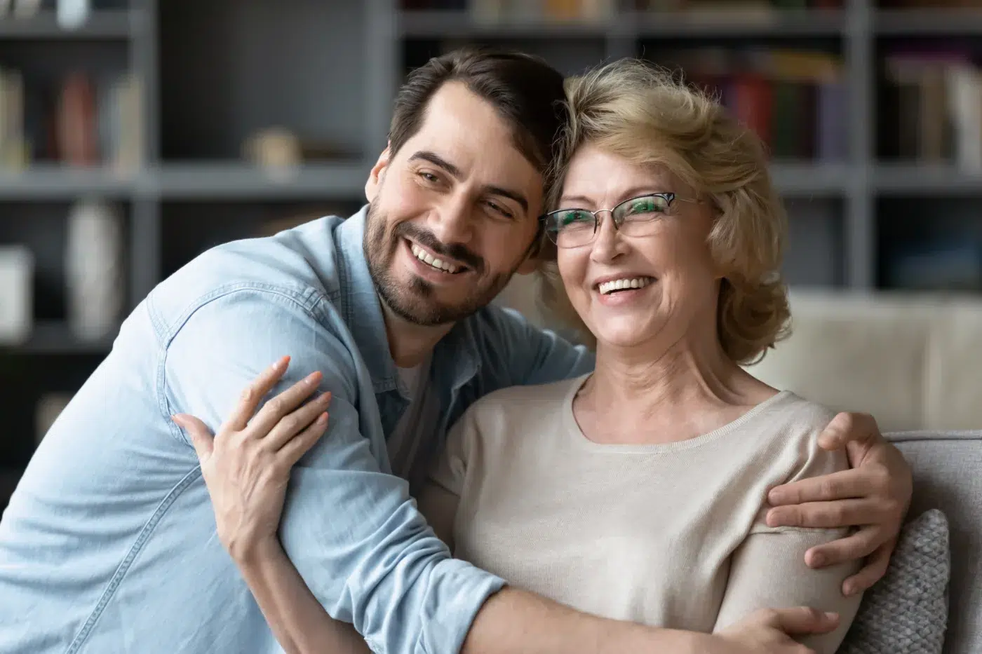 Smiling young man hug middle-aged mother - Community Choice Credit Union
