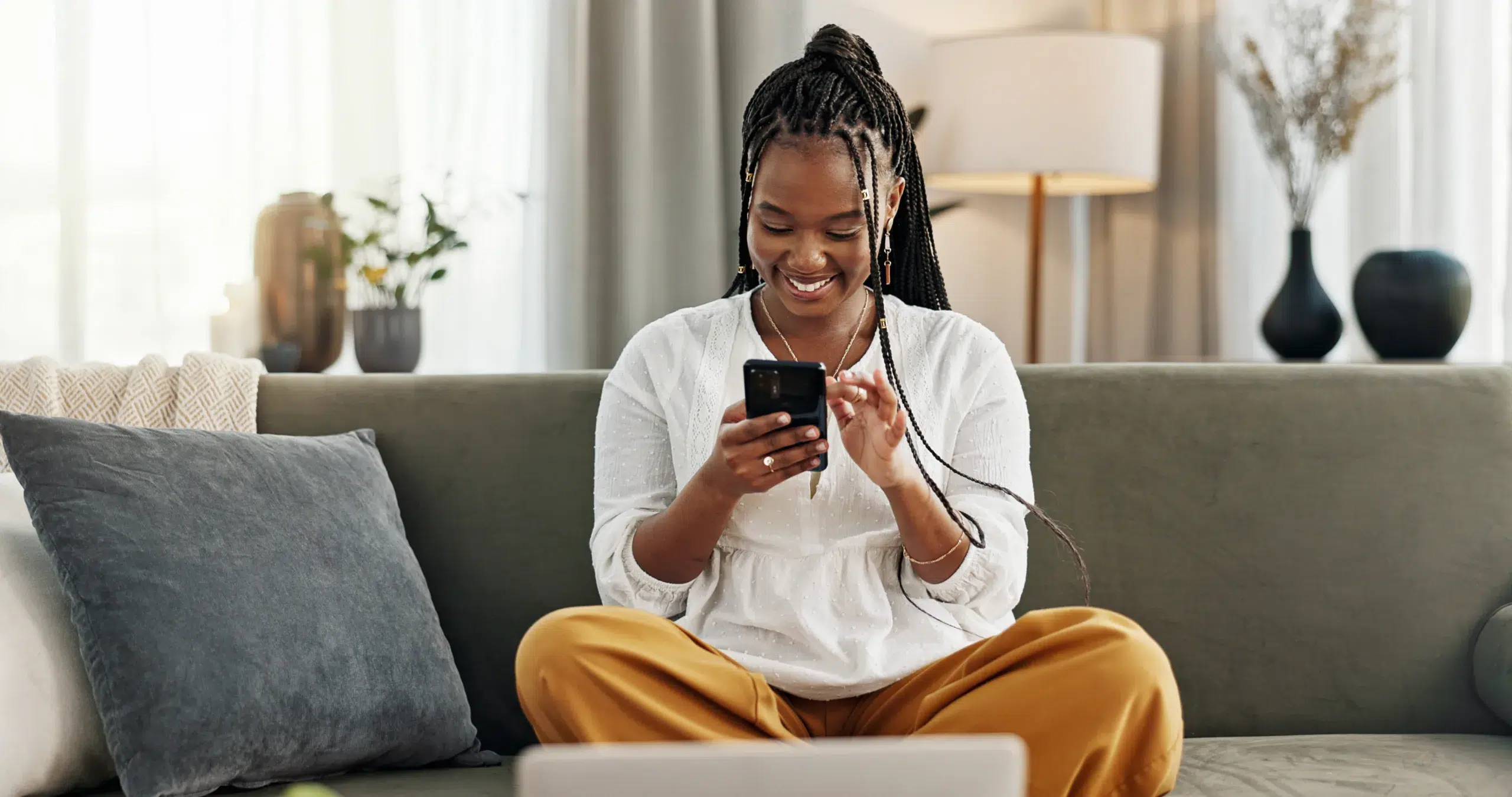 Happy woman enjoying easy banking on her mobile phone with Community Choice Credit Union