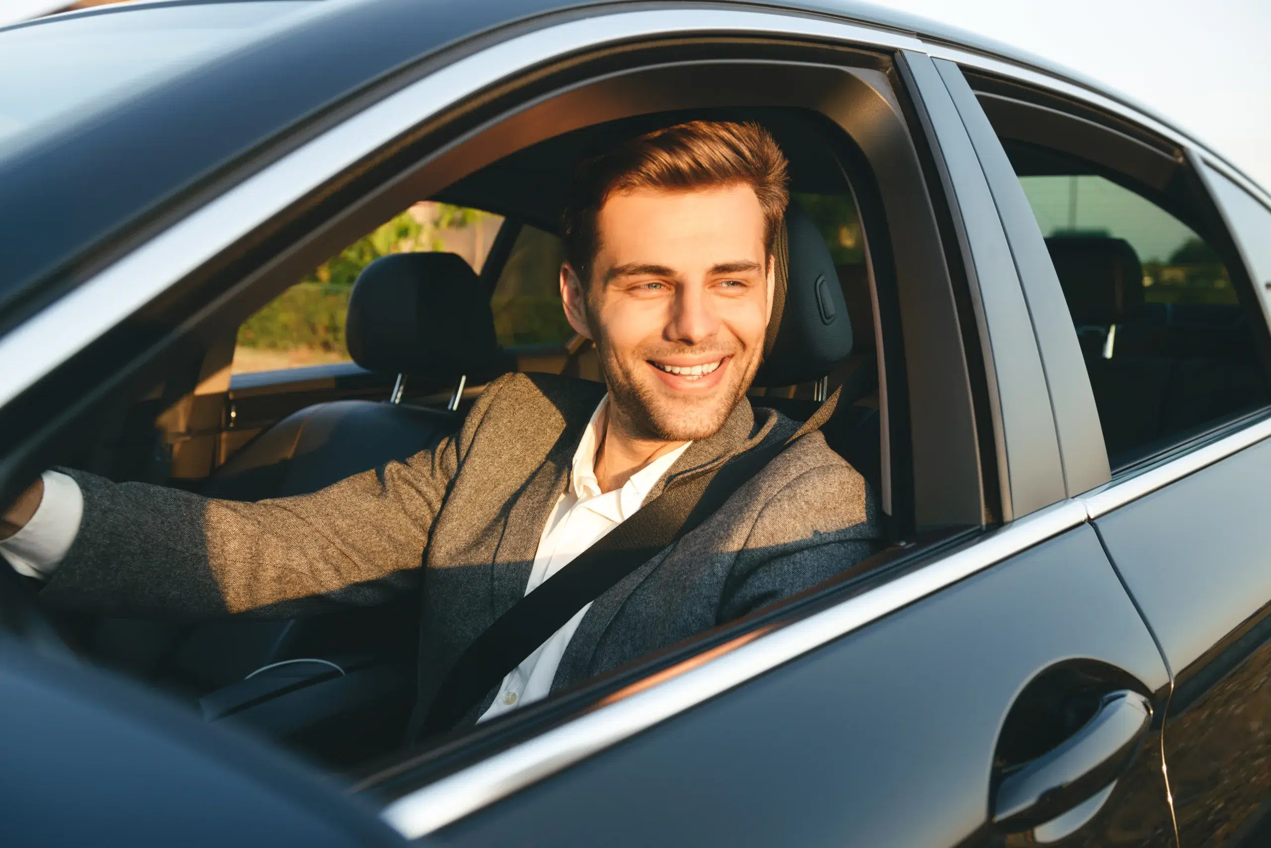 A smiling man enjoying his car in Michigan thanks to an auto loan from Community Choice Credit Union